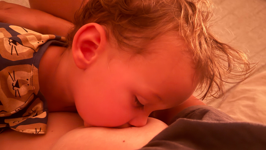 Mother breastfeeding newborn while learning breastfeeding positioning and attachment